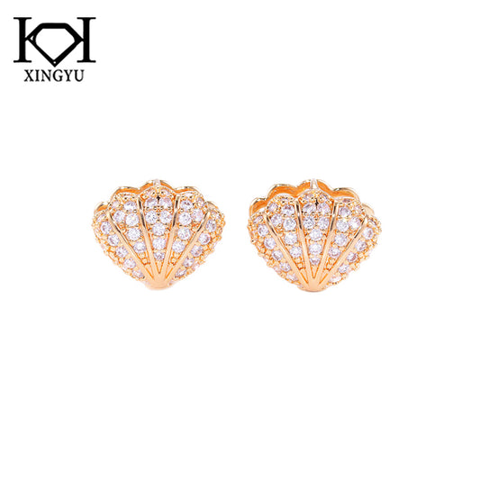 Brincos conchas cravejadas DCG0870